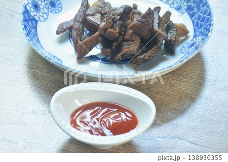fried crispy salty fermenting beef fat meat with pepper on plate dipping spicy chili sauce 138930355
