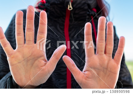 Woman making gesture with her hand outdoors Woman making gesture with her hand outdoors 138930598