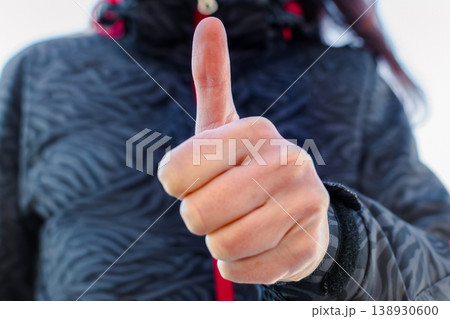 Woman making gesture with her hand outdoors Woman making gesture with her hand outdoors 138930600