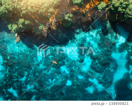 Aerial view of a kayak, azure water and green trees Aerial view of a kayak, azure water and green trees 138930821