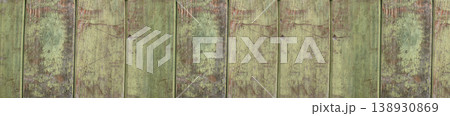 Horizontal banner showing aged wooden boards with peeling green paint  138930869
