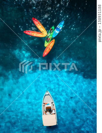 Aerial drone top view of colorful kayaks and motorboat on the sea 138931188