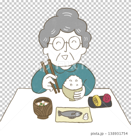 おばあさんがお箸を持って日本食のご飯を食べている 138931754