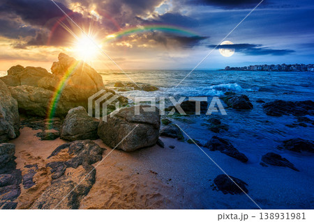 sandy beach landscape. day meet night. sun and moon over beautiful coastal seascape scenery. astrology background for autumn equinox vacation at the shore of black sea with rocks sandy beach landscape. day meet night. sun and moon over beautiful coastal seascape scenery. astrology background for autumn equinox vacation at the shore of black sea with rocks 138931981