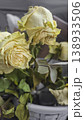 Dried yellow roses in the trash can, discarded dried flowers. Wilting, dead wood 138933506