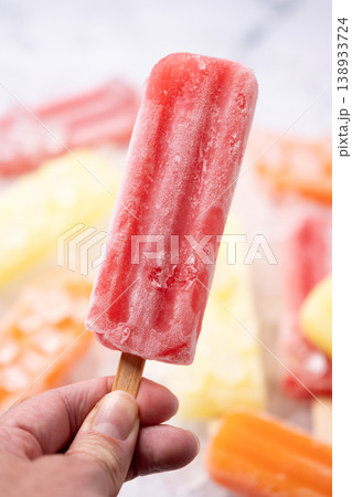 Hand holding red popsicle 138933724