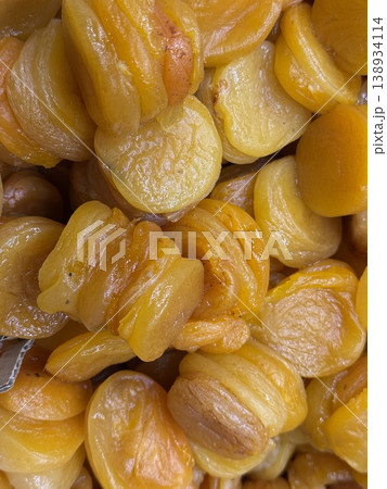 Close-up of dried apricots showcasing texture, color, and freshness, perfect for healthy food themes Close-up of dried apricots showcasing texture, color, and freshness, perfect for healthy food themes 138934114