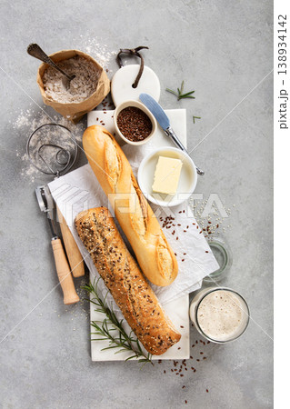 Baking Ingredients and Fresh Baguettes on Light Stone Surface 138934142