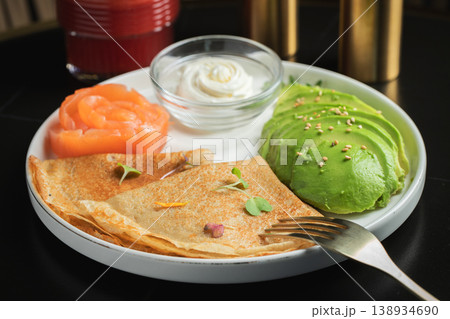 Roasted thin pancakes with smoked salmon and sauce 138934690