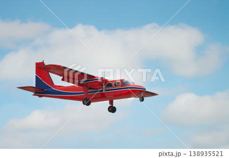 Red light aircraft in flight against blue sky Red light aircraft in flight against blue sky 138935521
