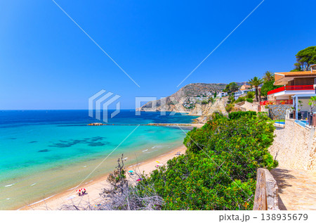 Aerial panoramic view coastline Costa Blanca coast with sandy beach, touristic path, residential houses in Calpe town Aerial panoramic view coastline Costa Blanca coast with sandy beach, touristic path, residential houses in Calpe town 138935679