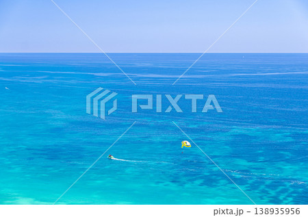 Parasailing in sea, motorboat powerboat with attached parachute Parasailing in sea, motorboat powerboat with attached parachute 138935956