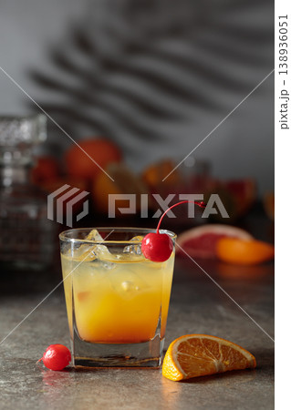 Cocktail with ice and orange juice garnished with maraschino cherry. Cocktail with ice and orange juice garnished with maraschino cherry. 138936051