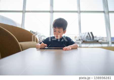 Young Boy Engaged in Drawing at Airport Lounge with Modern Design 138936281