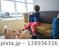 Young Child Playing in Airport Lounge with Backpack and Comfortable Seating 138936316