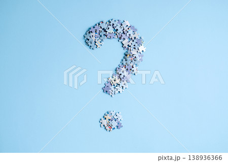 Puzzle pieces arranged in shape of large question mark on light blue background. Global conflict risks, geopolitical instability analysis, world order transition. 138936366