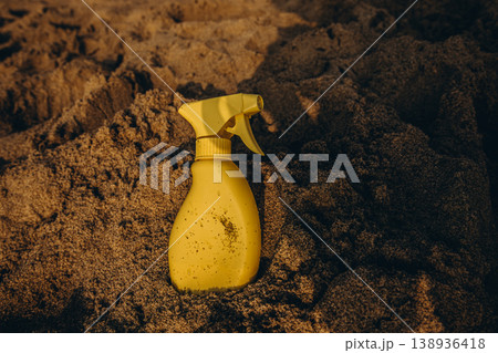 Yellow sunscreen spray bottle on dry sand beach Summer sun protection concept minimal cosmetic product mockup with copy space Yellow sunscreen spray bottle on dry sand beach Summer sun protection concept minimal cosmetic product mockup with copy space 138936418