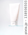 Blank cosmetic tube on glass shelf on light background 138936503