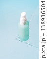 Frosted cosmetic pump bottle on blue background with soft light 138936504