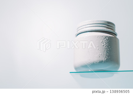 White cream jar on glass shelf White cream jar on glass shelf 138936505