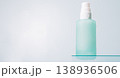 Frosted cosmetic bottle on glass shelf with light background 138936506