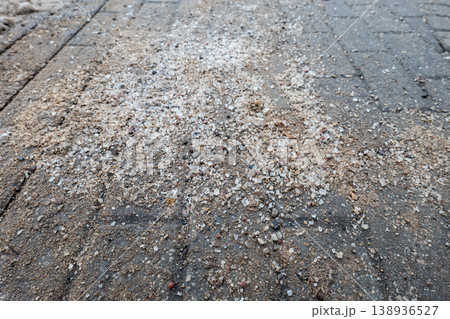Sand and Salt Spread on Asphalt Sidewalk for Winter Ice Safety Sand and Salt Spread on Asphalt Sidewalk for Winter Ice Safety 138936527