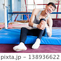 Injured male gymnast suffering from knee pain after bad landing 138936622