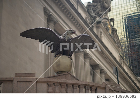 Bronze Eagle Watches Commuters Nearby. Guardian Eagle Sculpture Stands Tall Over City Bronze Eagle Watches Commuters Nearby. Guardian Eagle Sculpture Stands Tall Over City 138936692