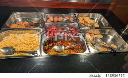 Breakfast buffet food in a hotel restaurant with eggs, vegetables, sausages, bread, and pie 138936715