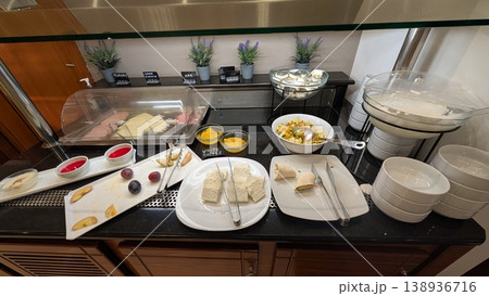 Cheese, ham, fruits, and yogurt at the breakfast buffet in the hotel 138936716