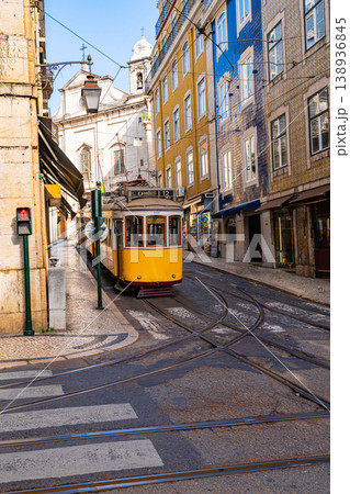 Traditional yellow tram on narrow street in Lisbon city center Traditional yellow tram on narrow street in Lisbon city center 138936845