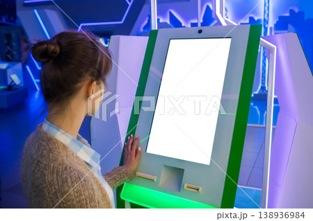 White screen concept - woman looking at blank white display kiosk at exhibition White screen concept - woman looking at blank white display kiosk at exhibition 138936984