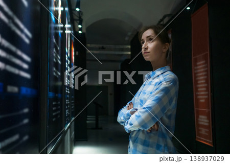 Young woman looking around in modern historical museum Young woman looking around in modern historical museum 138937029