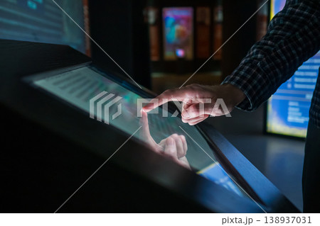 Man using interactive touchscreen display at modern museum or exhibition Man using interactive touchscreen display at modern museum or exhibition 138937031