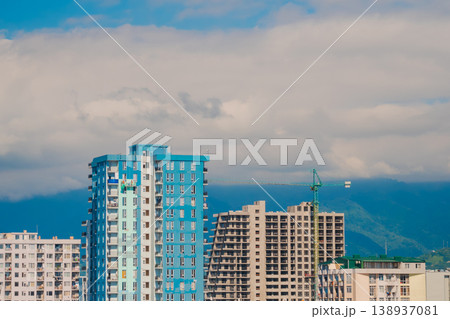 Turquoise tower crane and unfinished building construction Turquoise tower crane and unfinished building construction 138937081