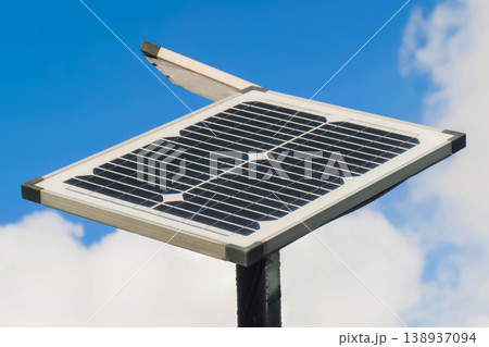 View of solar panels against white clouds in the blue sky - close up View of solar panels against white clouds in the blue sky - close up 138937094