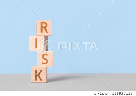 Wooden blocks on a table with the word risk. Risk assessment crisis concept. Financial analysis solution, real estate business management. Plan to stop economic risk. Wooden blocks on a table with the word risk. Risk assessment crisis concept. Financial analysis solution, real estate business management. Plan to stop economic risk. 138937113