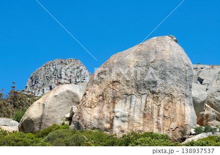 Rocks and boulders on a mountain peak with green lush bush growing on Lions Head in Cape Town with sky and copyspace. Large area of wilderness landscape with calm fresh air and harmony in nature Rocks and boulders on a mountain peak with green lush bush growing on Lions Head in Cape Town with sky and copyspace. Large area of wilderness landscape with calm fresh air and harmony in nature 138937537