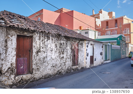 Exterior of decaying brick buildings with peeling paint in a street of Santa Cruz de La Palma. Architectural details of an abandoned rustic property with damaged and aged doors or entrances outside Exterior of decaying brick buildings with peeling paint in a street of Santa Cruz de La Palma. Architectural details of an abandoned rustic property with damaged and aged doors or entrances outside 138937650