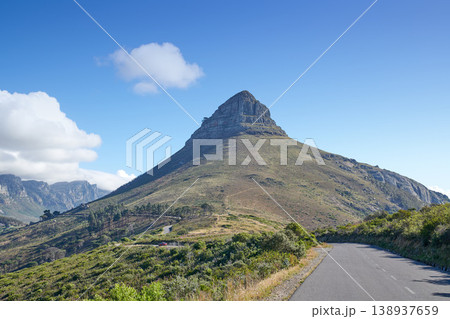 A road leading to Lions Head in Cape Town, South Africa against blue sky copyspace on a sunny morning. A highway along a peaceful mountain landscape with scenic views or lush green bushes and trees A road leading to Lions Head in Cape Town, South Africa against blue sky copyspace on a sunny morning. A highway along a peaceful mountain landscape with scenic views or lush green bushes and trees 138937659