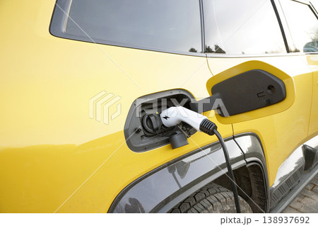 Close up of power supply plugged into an Yellow electric car Close up of power supply plugged into an Yellow electric car 138937692