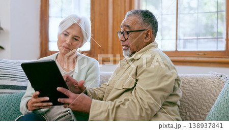 Tablet, love and an elderly couple on a sofa in the living room of their home to search social media together. Diversity, app or technology with a senior man and woman in the apartment for retirement 138937841