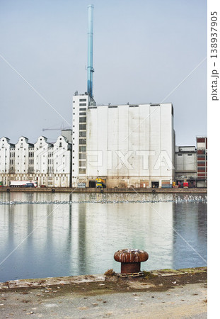 A factory seen from across a body of water, industrial industry adding to air pollution, contamination and environmental pollution, deathly toxic for the planet and global state of wellbeing 138937905
