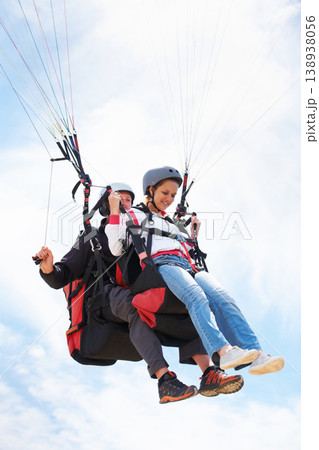 People, paragliding and happy in sky, together or extreme sport with freedom for fitness. Coach, partnership and person on adventure, helmet or fearless with backpack, parachute or flight with clouds People, paragliding and happy in sky, together or extreme sport with freedom for fitness. Coach, partnership and person on adventure, helmet or fearless with backpack, parachute or flight with clouds 138938056