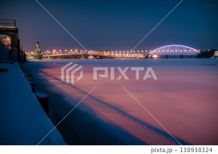 Havana bridge and Podilskyi Bridge in Kyiv at winter night with colorful illumination and the frozen Dnipro river 138938324