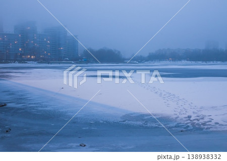 Winter landscape. Frozen river in fog on a cloudy day. Tall buildings in the fog on the river bank. Dnipro. Kyiv, Ukraine 138938332