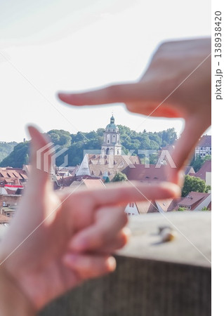 Church of St. Afra in focus of female hands. View of red roofs and cozy houses of Meissen.Top view of Meissen, Germany Church of St. Afra in focus of female hands. View of red roofs and cozy houses of Meissen.Top view of Meissen, Germany 138938420