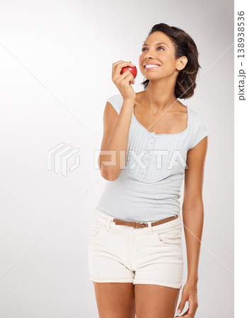 Health, apple and young woman in a studio for wellness, nutrition or organic weight loss diet. Smile, vitamins and female person from Mexico eating a fruit for healthy vegan snack by white background 138938536