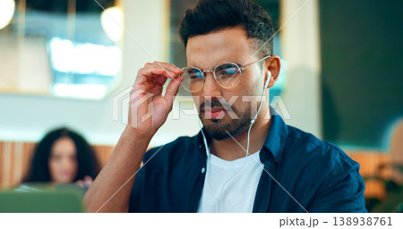 Man, reading glasses and cafe for online research, remote work and review of website and analysis. Freelancer worker or designer in coffee shop or restaurant with computer and music for internet info Man, reading glasses and cafe for online research, remote work and review of website and analysis. Freelancer worker or designer in coffee shop or restaurant with computer and music for internet info 138938761