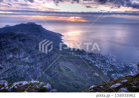 Beautiful landscape of an iconic landmark and famous travel or vacation destination in South Africa at sunset. Aerial view of the sea, Table Mountain and a city on a cloudy evening with copy space 138938962